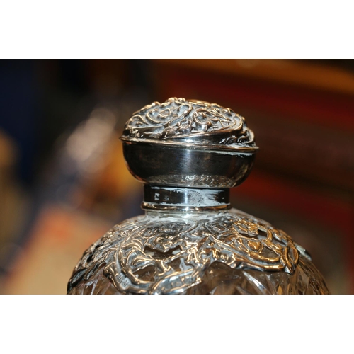 687 - Two silver mounted glass globular scent bottles, 11cm high.