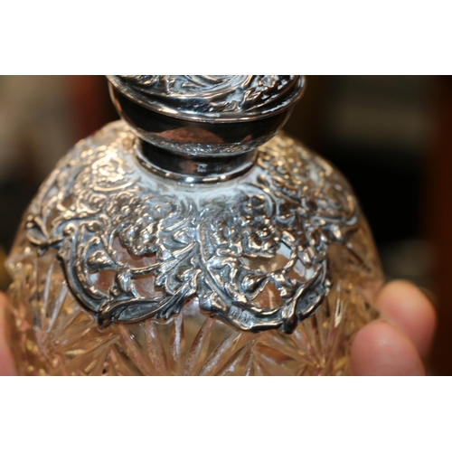 687 - Two silver mounted glass globular scent bottles, 11cm high.