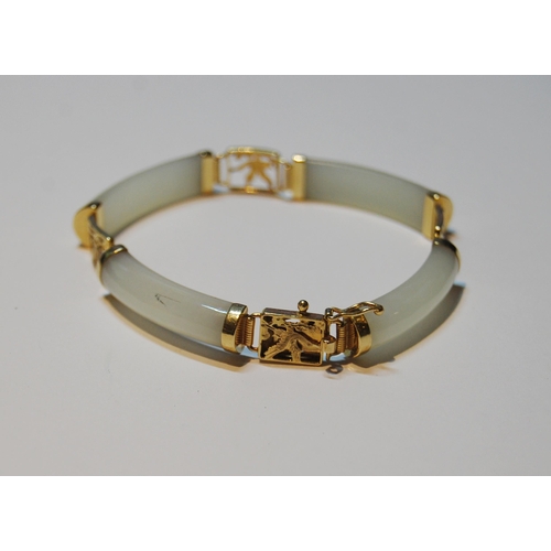 60 - Chinese pale grey jade bangle, in gold, '14k'.