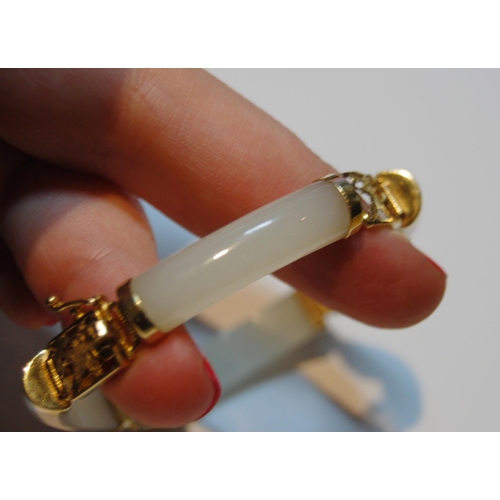 60 - Chinese pale grey jade bangle, in gold, '14k'.