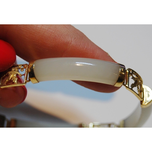 60 - Chinese pale grey jade bangle, in gold, '14k'.