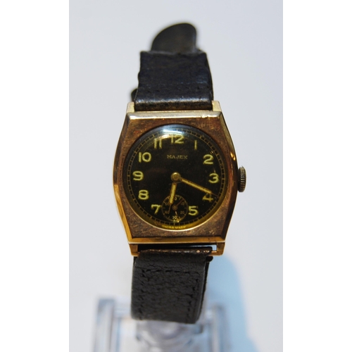 129 - Majex gent's 9ct gold watch of tonneau shape, 1945, on strap.