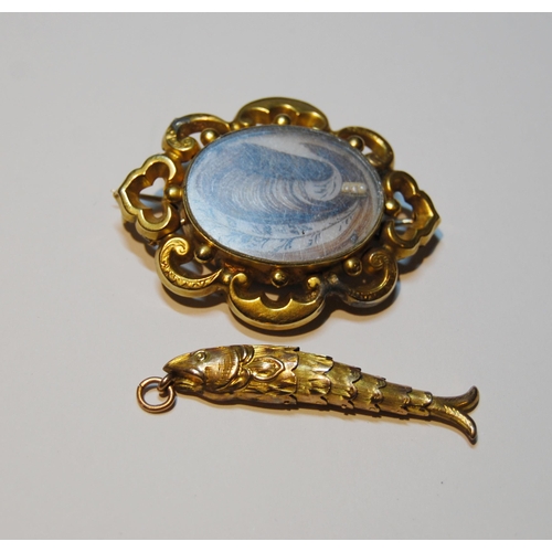 66 - Victorian gold flexible fish pendant, probably 9ct, and a mourning brooch, probably 15ct.