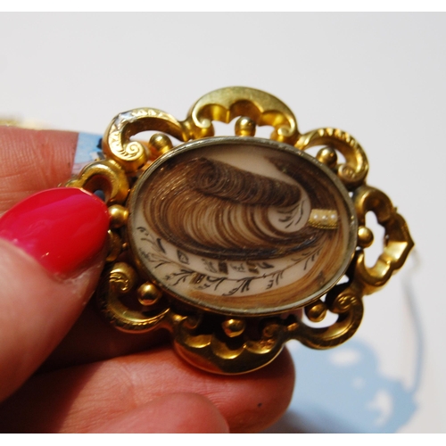 66 - Victorian gold flexible fish pendant, probably 9ct, and a mourning brooch, probably 15ct.