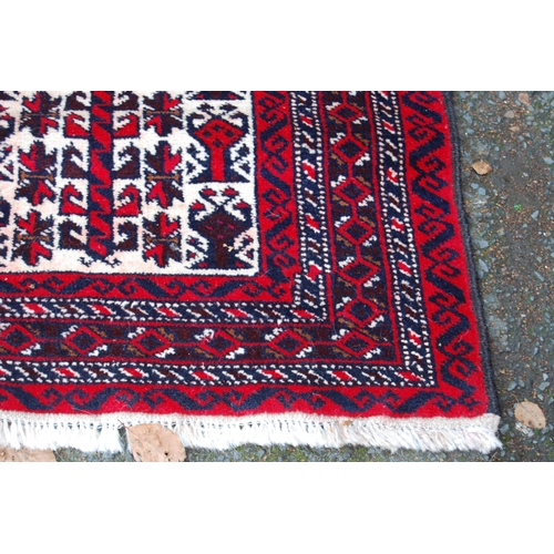 326 - Afghan Belouch hand-knotted rug with all-over geometric guls and motifs on red, blue and cream groun... 