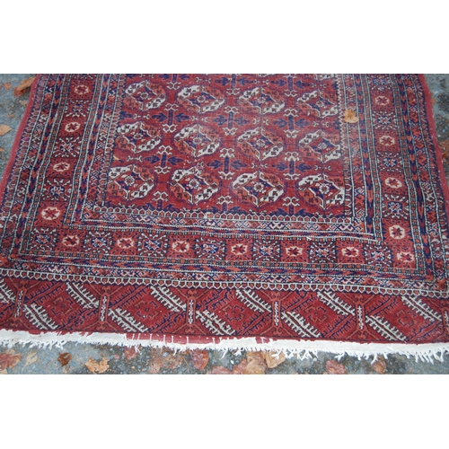 327 - Turkoman Tekke hand-knotted rug with seven rows of four guls and further geometric motifs to the bor... 