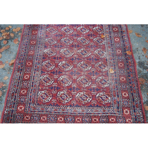 327 - Turkoman Tekke hand-knotted rug with seven rows of four guls and further geometric motifs to the bor... 