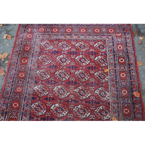 327 - Turkoman Tekke hand-knotted rug with seven rows of four guls and further geometric motifs to the bor... 