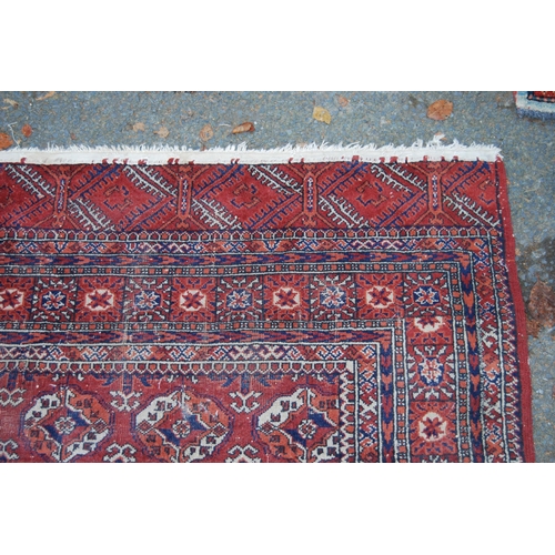 327 - Turkoman Tekke hand-knotted rug with seven rows of four guls and further geometric motifs to the bor... 