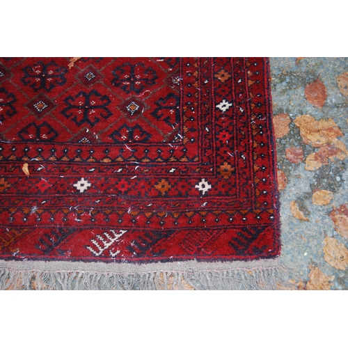 328 - Afghan Belouch hand-knotted rug with geometric guls to the centre flanked by further geometric motif... 