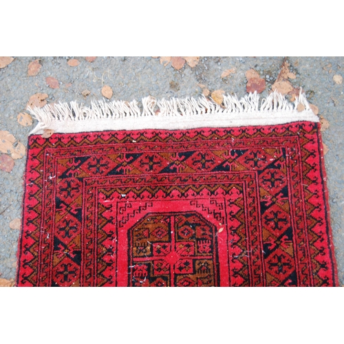 329 - Afghan Belouch hand-knotted rug with three large geometric guls to the centre and further geometric ... 