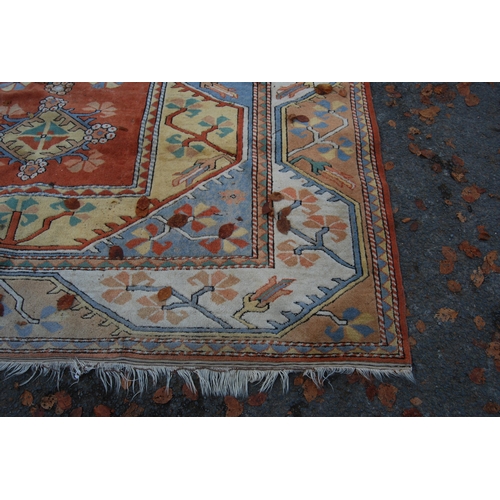 320 - Turkish Milas hand-knotted carpet with five geometric guls to the centre flanked by further geometri... 