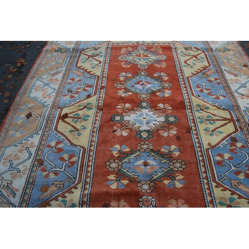 320 - Turkish Milas hand-knotted carpet with five geometric guls to the centre flanked by further geometri... 