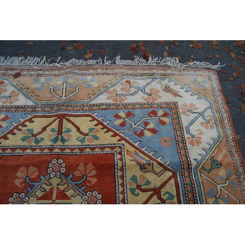 320 - Turkish Milas hand-knotted carpet with five geometric guls to the centre flanked by further geometri... 