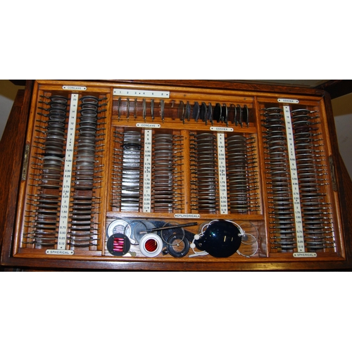 375 - Vintage oak optician's cabinet with glazed viewing top enclosing lenses in fitted compartments above... 