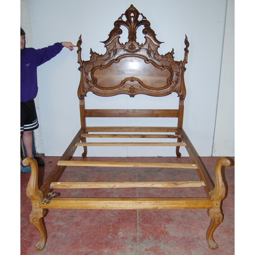 377 - French walnut double bed, the large carved head rest decorated with applied scrolls, with side rails... 