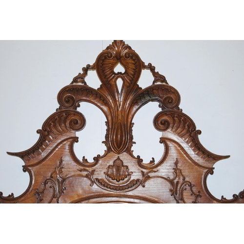 377 - French walnut double bed, the large carved head rest decorated with applied scrolls, with side rails... 