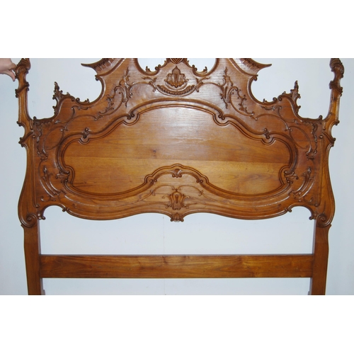 377 - French walnut double bed, the large carved head rest decorated with applied scrolls, with side rails... 