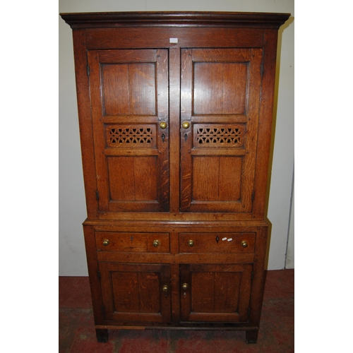 378 - 18th century Welsh oak cheese cupboard, the two panelled doors with pierced panels to the centre enc... 