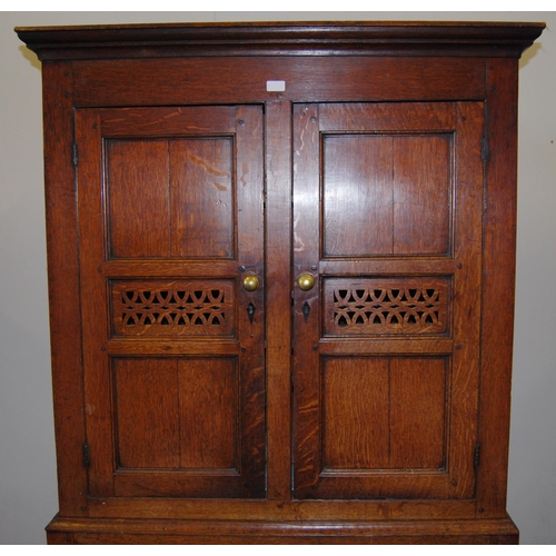 378 - 18th century Welsh oak cheese cupboard, the two panelled doors with pierced panels to the centre enc... 