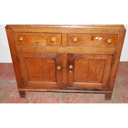 378 - 18th century Welsh oak cheese cupboard, the two panelled doors with pierced panels to the centre enc... 