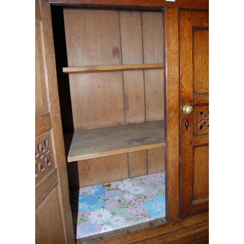 378 - 18th century Welsh oak cheese cupboard, the two panelled doors with pierced panels to the centre enc... 