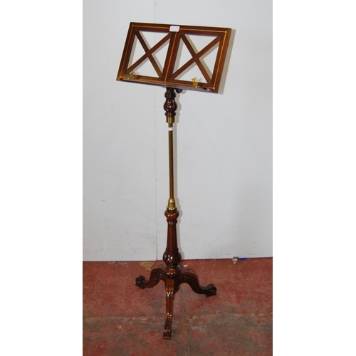 391 - Victorian-style mahogany and brass music stand on turned column and tripod supports with scroll feet... 