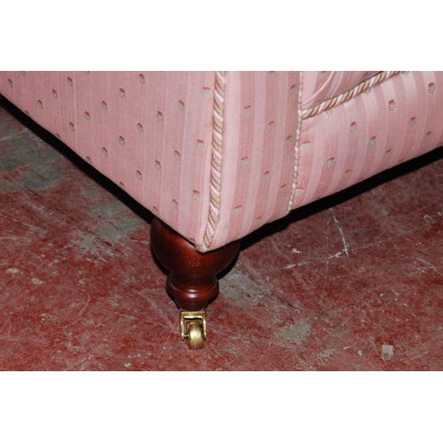 398 - Victorian-style two-seater sofa upholstered in pink moquette, with scatter cushions, on brass castor... 