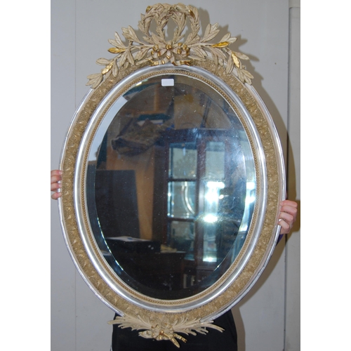 399 - French-style painted wood and gesso oval wall mirror with applied leaf garland surmounts, all-over m... 