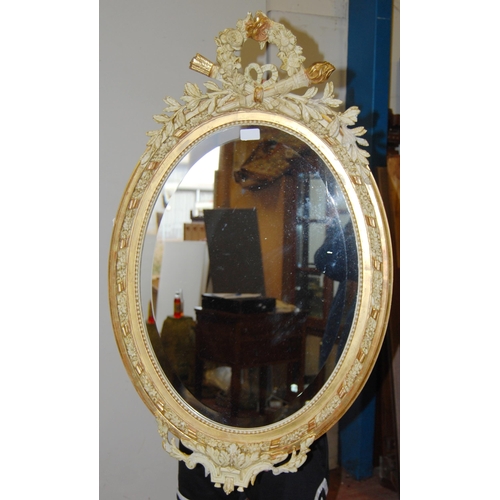 400 - French-style painted wood and gesso oval wall mirror with applied leaf garland surmounts, all-over m... 