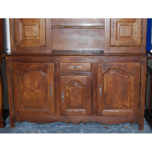 401 - Continental oak dresser, 20th century, the top section with open shelving flanked by panelled cupboa... 