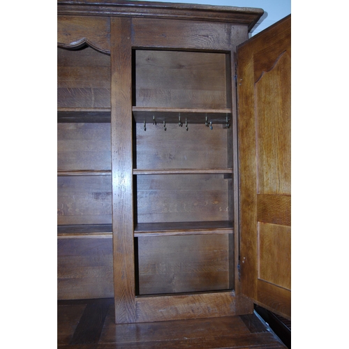 401 - Continental oak dresser, 20th century, the top section with open shelving flanked by panelled cupboa... 