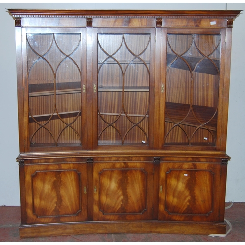 403 - Mahogany bookcase/display cabinet, probably by Bevan-Funnell, with three concave astragal doors encl... 