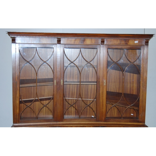 403 - Mahogany bookcase/display cabinet, probably by Bevan-Funnell, with three concave astragal doors encl... 