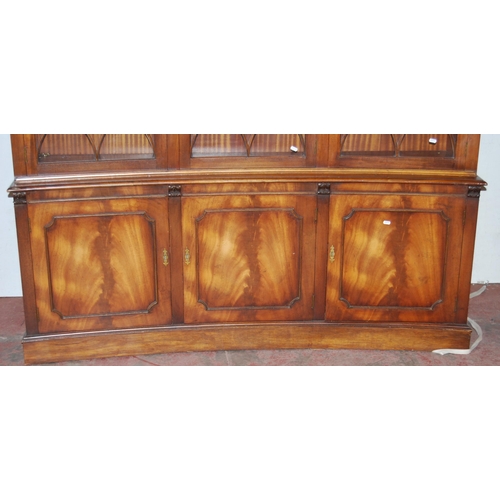 403 - Mahogany bookcase/display cabinet, probably by Bevan-Funnell, with three concave astragal doors encl... 