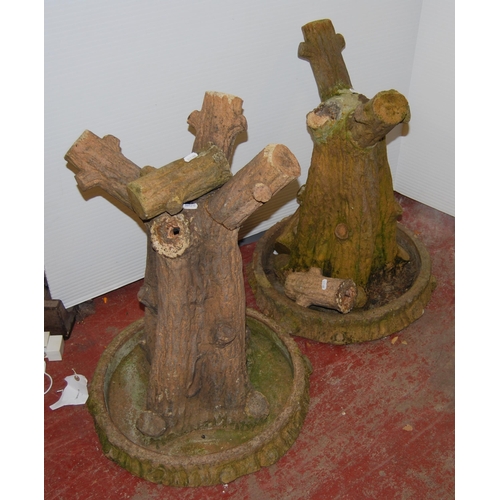 404 - Pair of garden terracotta pedestal tables of naturalistic form, the circular tops on tree-type stump... 