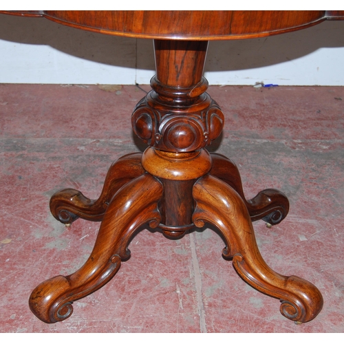 413 - Victorian rosewood tea table with shaped fold-over top, on turned baluster column, quadripartite sup... 