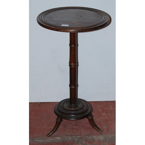 415 - Antique mahogany campaign-style wine table, the saucer top on turned column, platform base and scrol... 