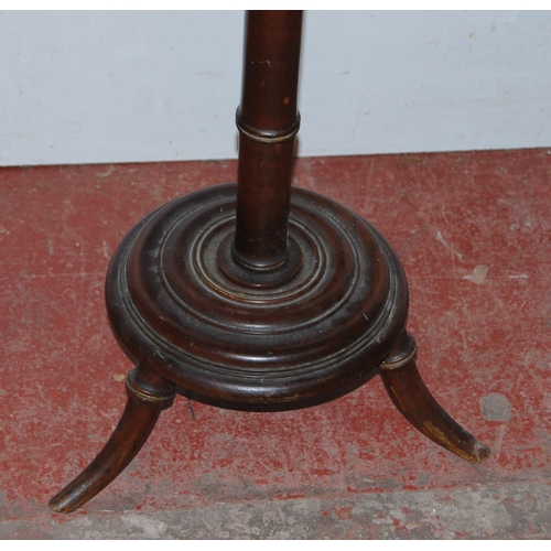 415 - Antique mahogany campaign-style wine table, the saucer top on turned column, platform base and scrol... 