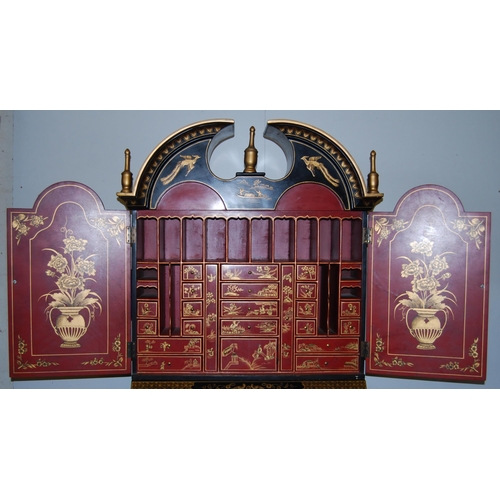 421 - Chinoiserie black lacquered bureau bookcase, the top section with two doors enclosing red lacquered ... 