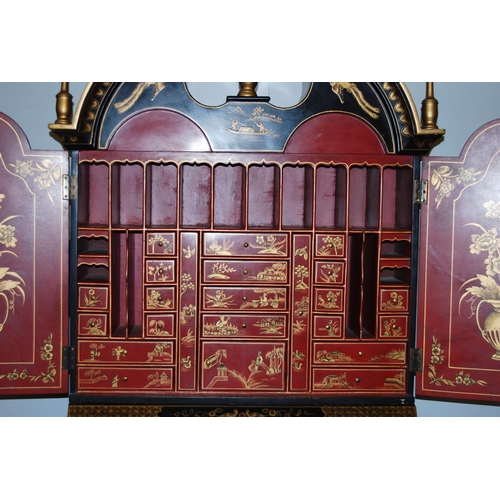 421 - Chinoiserie black lacquered bureau bookcase, the top section with two doors enclosing red lacquered ... 