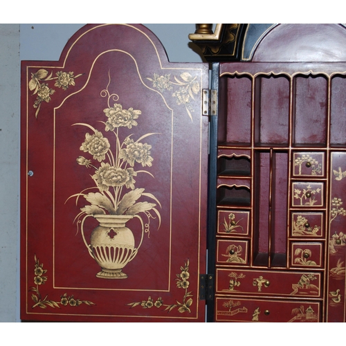 421 - Chinoiserie black lacquered bureau bookcase, the top section with two doors enclosing red lacquered ... 