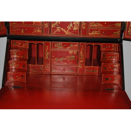 421 - Chinoiserie black lacquered bureau bookcase, the top section with two doors enclosing red lacquered ... 