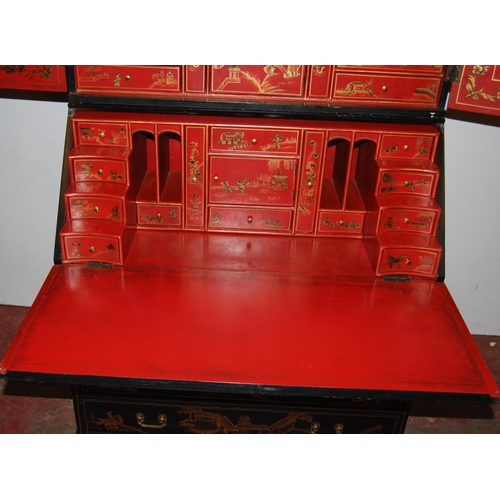 421 - Chinoiserie black lacquered bureau bookcase, the top section with two doors enclosing red lacquered ... 