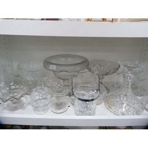 100 - Collection of glassware to include large comports, decanters, ice bucket etc (one shelf).