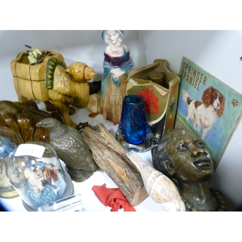 104 - Collection of decorative items to include cat model, model bird, camel, ornaments etc (one shelf).