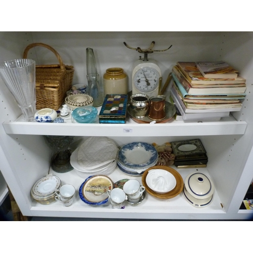 106 - Set of Salter scales, picnic basket, cookery books, blue and white plates, lamp etc (two shelves).