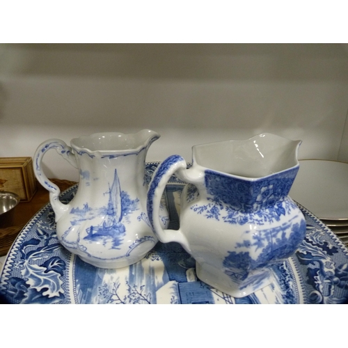 111 - 19th century blue and white ashet, two blue and white jugs, stoneware crock etc (one shelf).