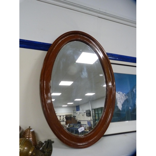 126 - Mahogany oval framed wall mirror.