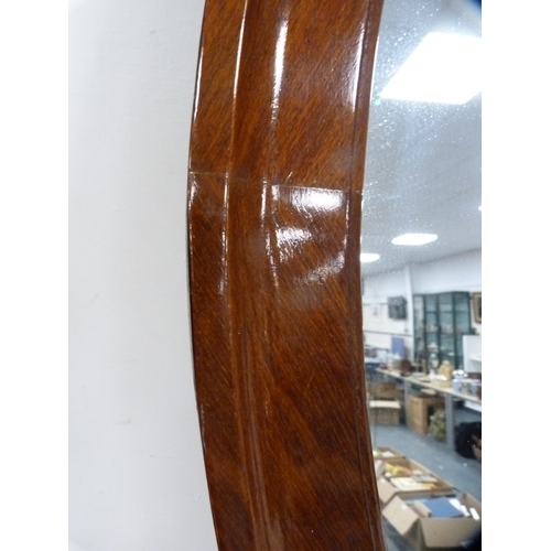 126 - Mahogany oval framed wall mirror.